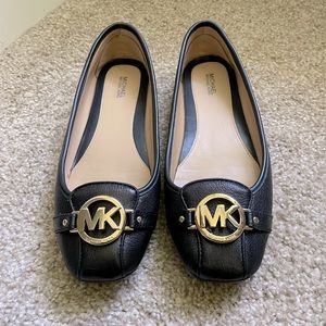 The Fulton Moccasin flat by Michael Kors in black with gold hardware size 9.5
